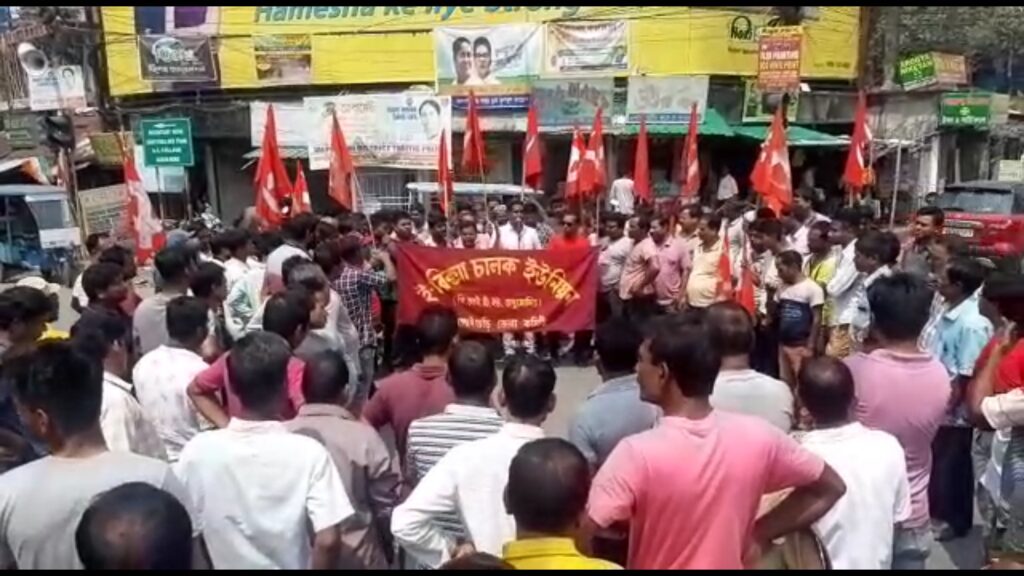 Toto drivers pass the police barricade in Jalpaiguri